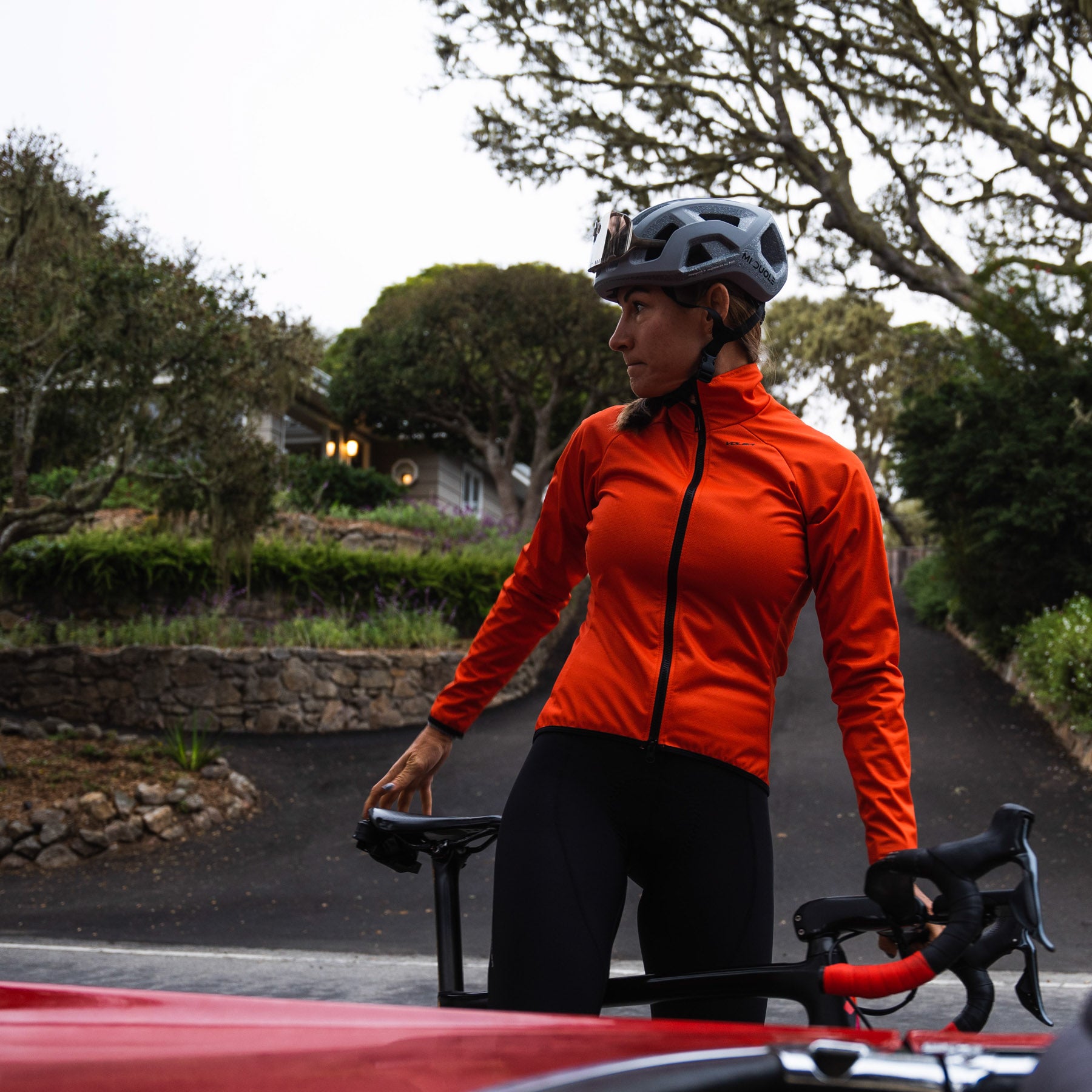 cyclist in the wearing bright jacket posing