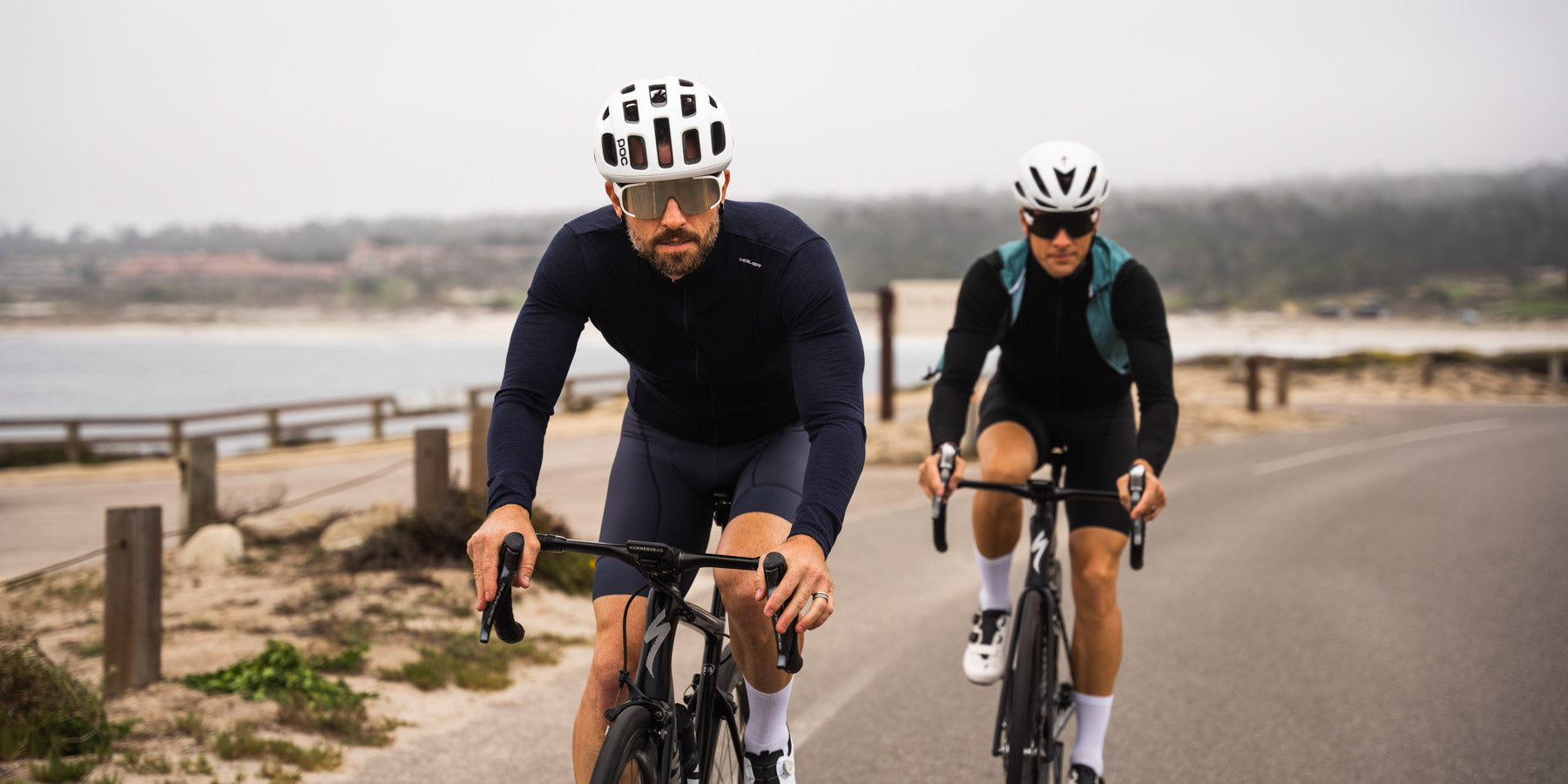 cyclist wearing long sleeve merino wool jerseys with coastline in back ground