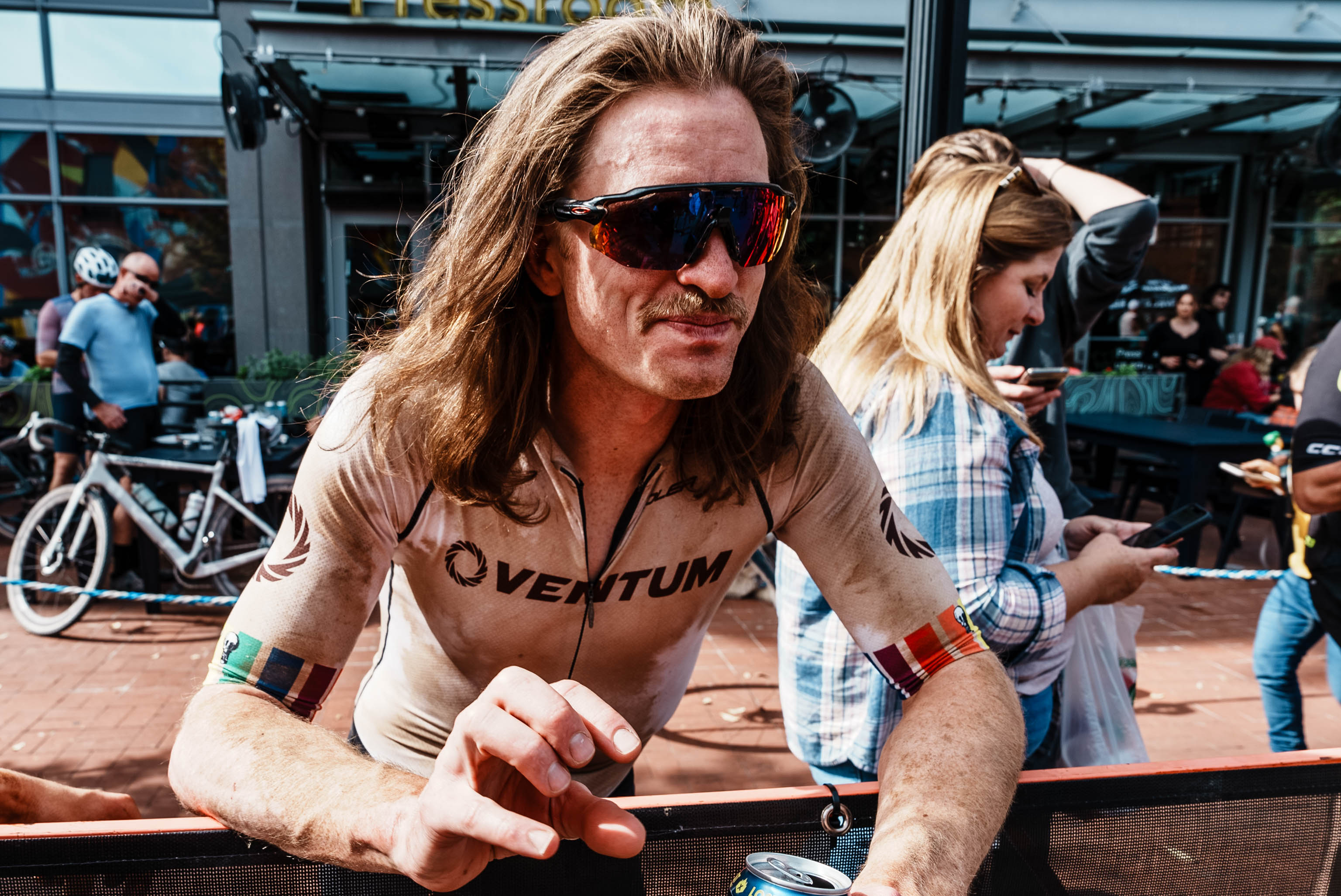 cyclist enjoying a beverage after a race