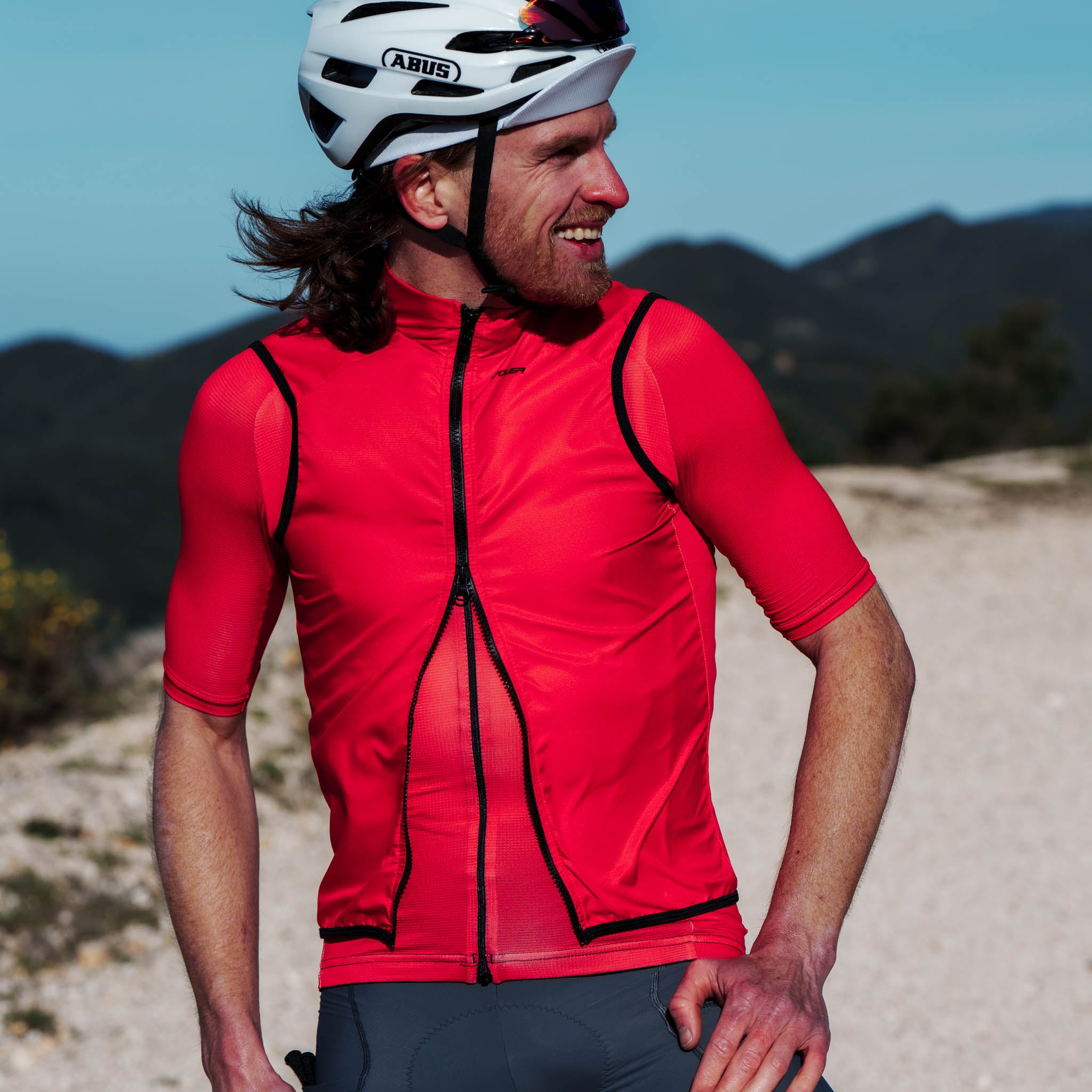 cyclist smiling - red jersey and vest