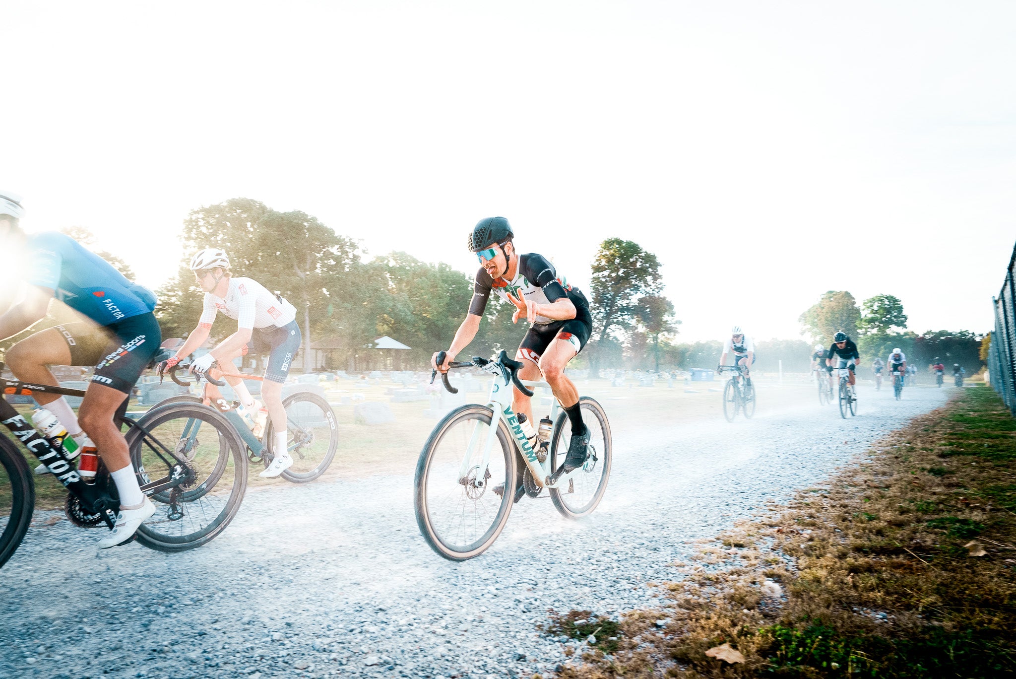 Cyclists riding on gravel road