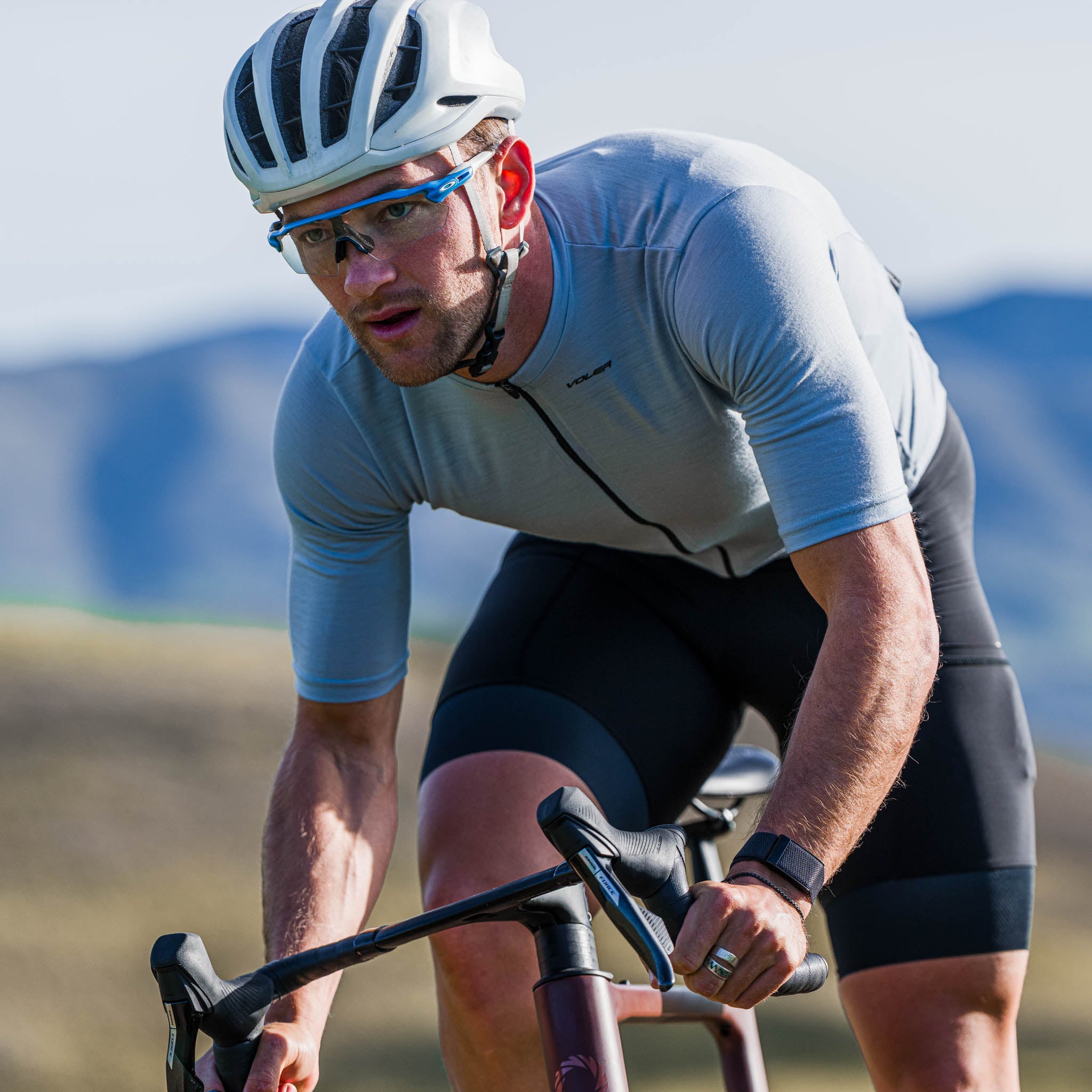 cyclist wearing wool short sleeve jersey blurred background