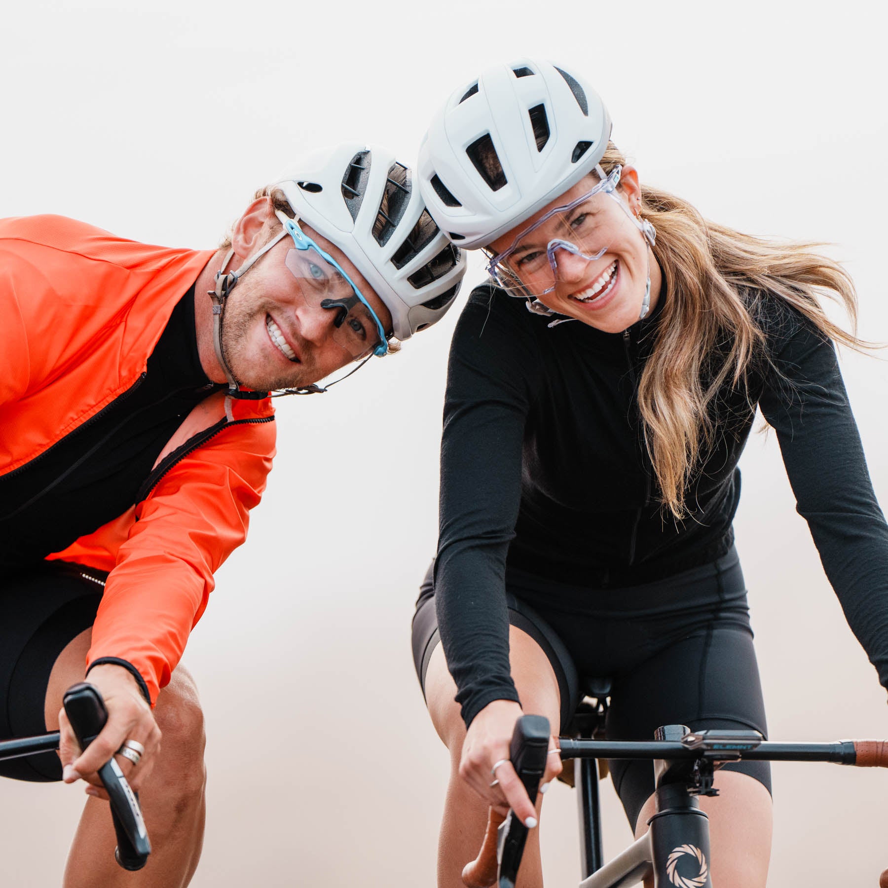 man and woman cyclists posed with big smiles