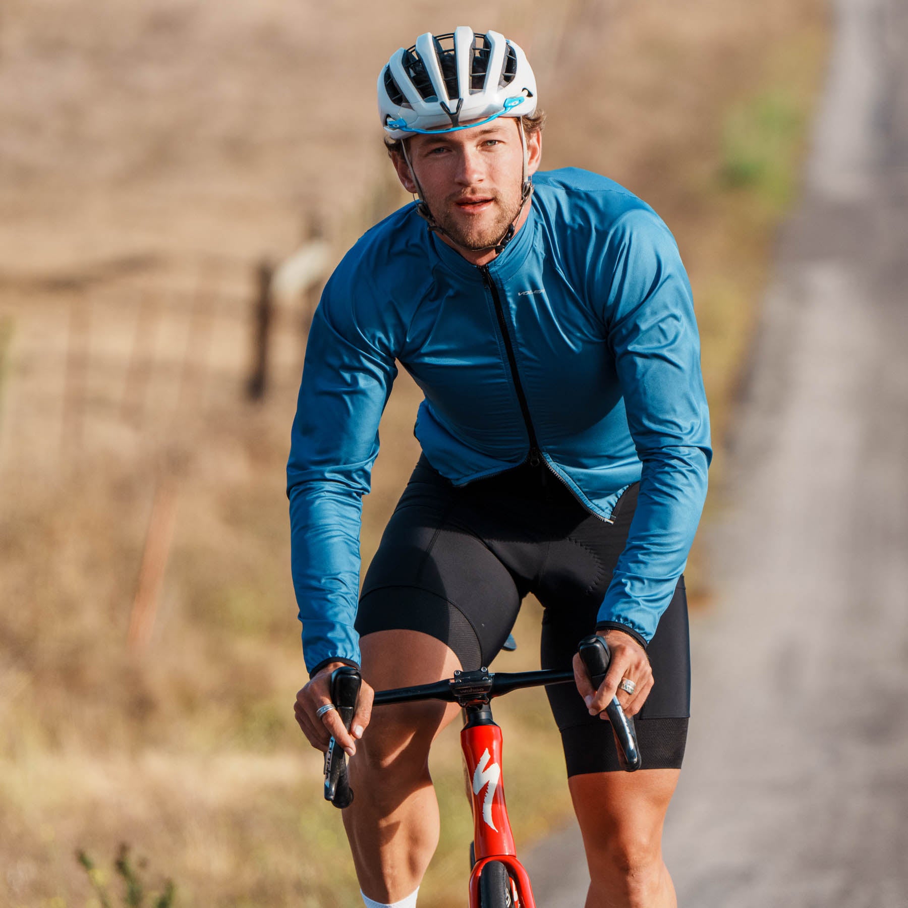 cyclist in blue jacket riding