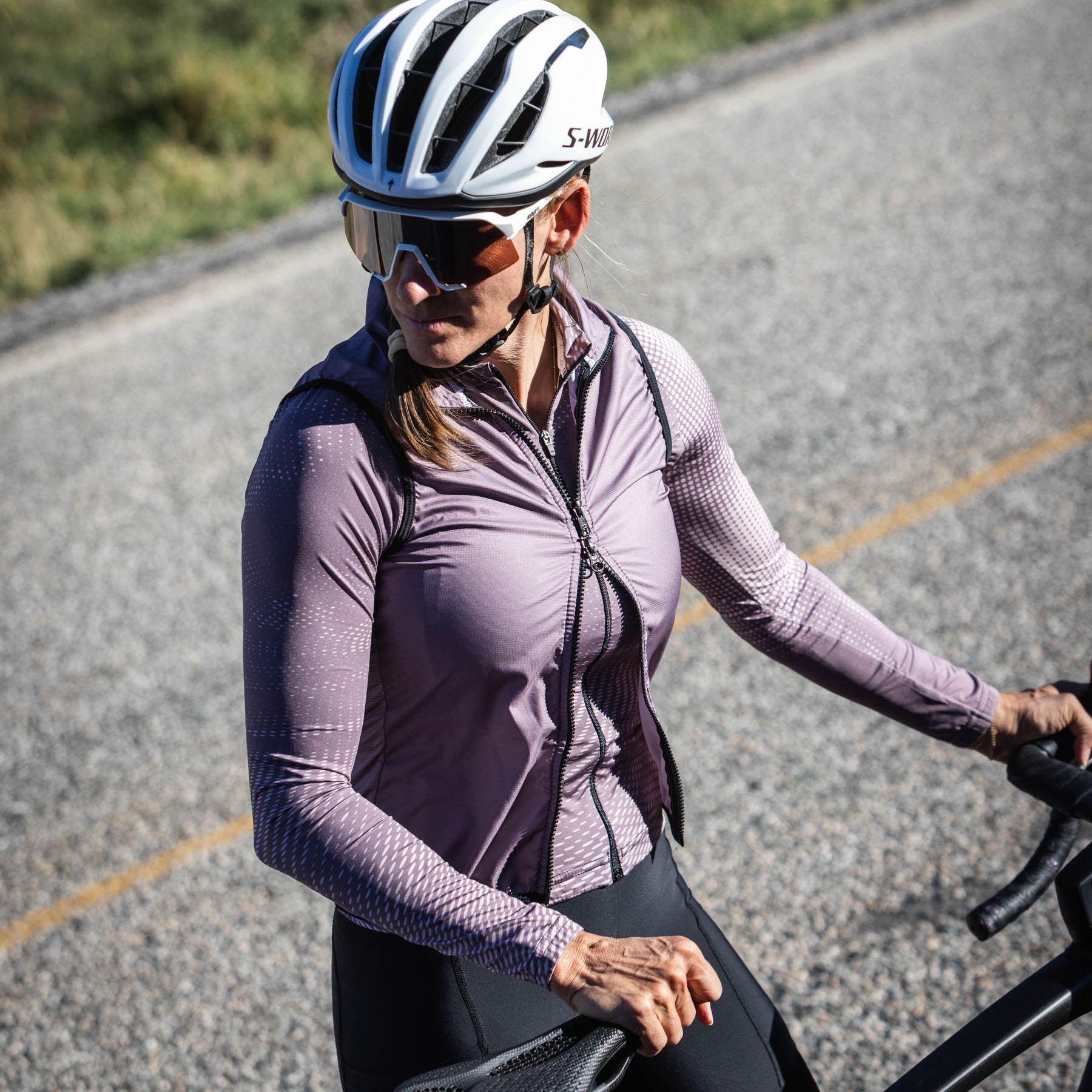 female cyclist posting with bike