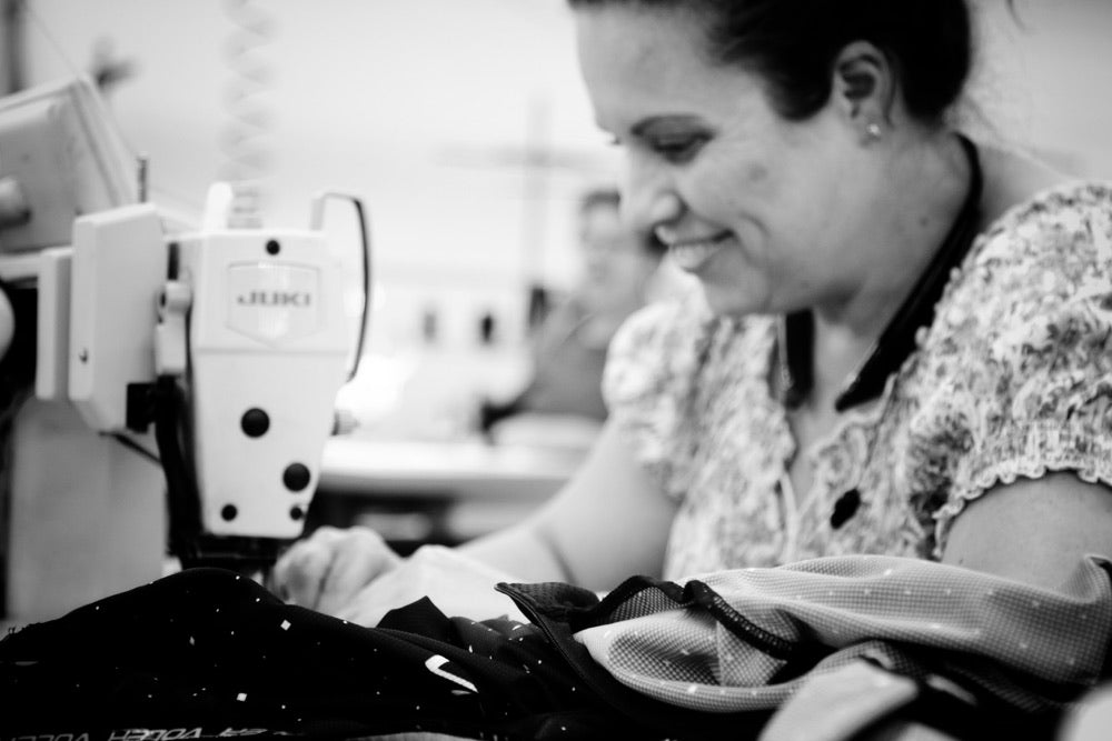 Fabric being handled at a sewing machine in the Voler factory.